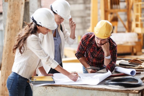 Two,Female,Inspectors,And,Architects,Discuss,With,Head,Engineer,About